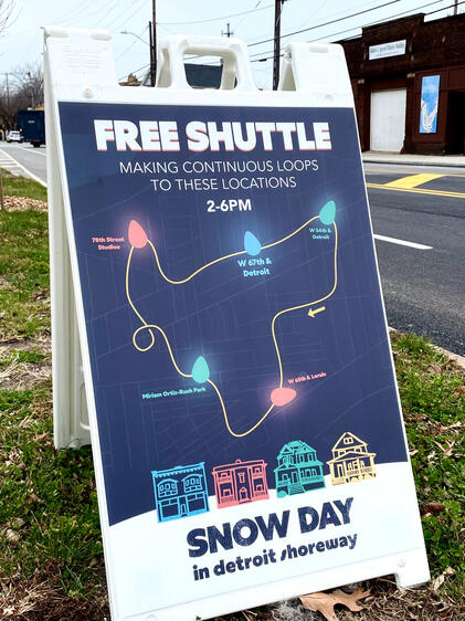 Snow Day festival shuttle map on sandwich boards